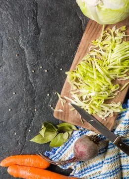 Beets, carrots and cabbage during cooking. Composition on a dark background Foto stock