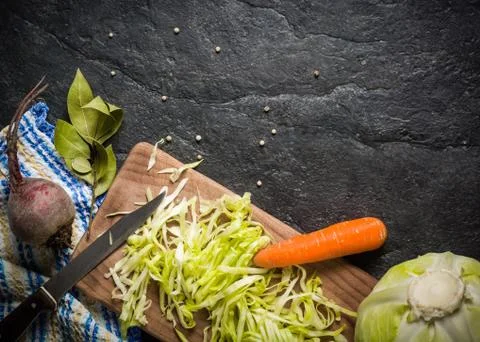 Beets, carrots and cabbage during cooking. Composition on a dark background Foto stock
