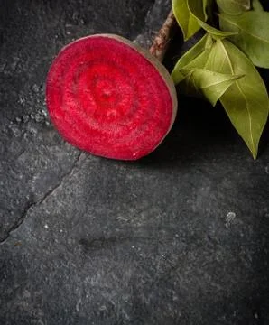 Beets cut on a black stone background. Stock Photos