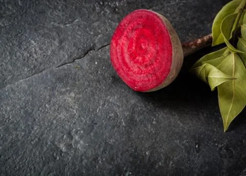 Beets cut on a black stone background. Foto stock