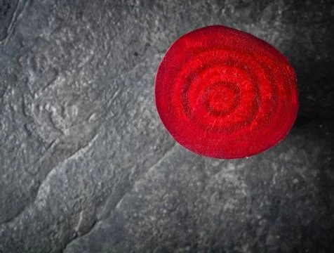 Beets cut on a black stone background. Stock Photos