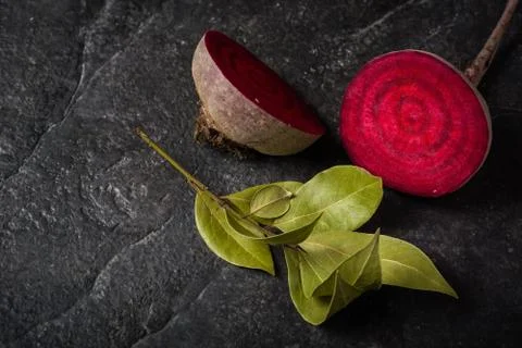 Beets cut on a black stone background. Stock Photos
