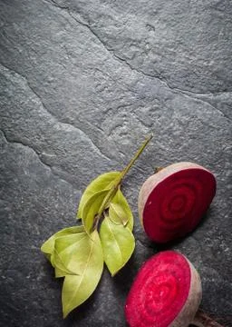 Beets cut on a black stone background Stock Photos