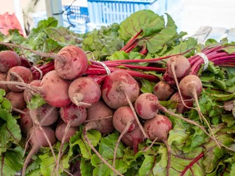 Beets sitting on table on display at an outdoor grocery mart Stock Photos