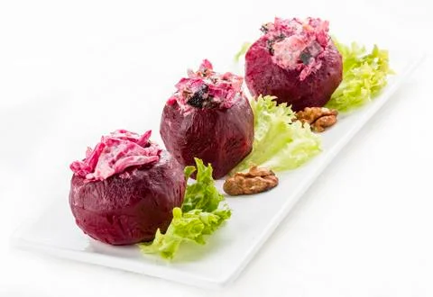 Beets stuffed with herring and nuts. Vegetarian dish. On white background Stock Photos