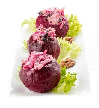 Beets stuffed with herring and nuts. Vegetarian dish. On white background Stock Photos