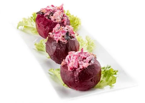 Beets stuffed with herring and nuts. Vegetarian dish. On white background Stock Photos