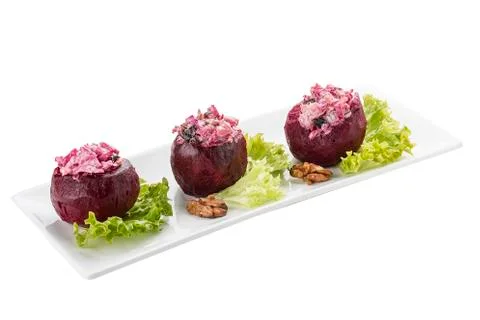 Beets stuffed with herring and nuts. Vegetarian dish. On white background Stock Photos