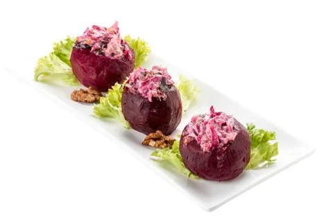 Beets stuffed with herring and nuts. Vegetarian dish. On white background Stock Photos