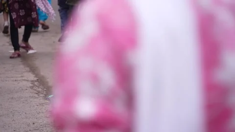 A beggar is getting drunk in the middle of the fair. Stock Footage 345929787