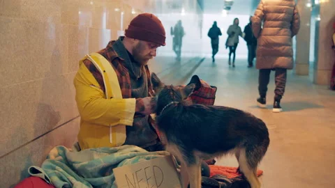 A beggar is treating his dog while eating noodles Vidéo 169274306