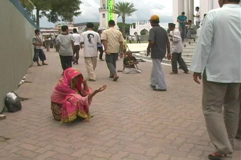 Beggar woman outside mosque Stock Footage