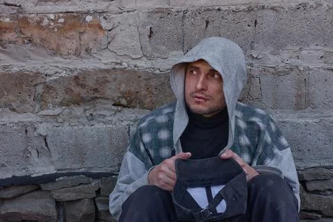 A beggar with wounded lips asks for alms. Stock Photos