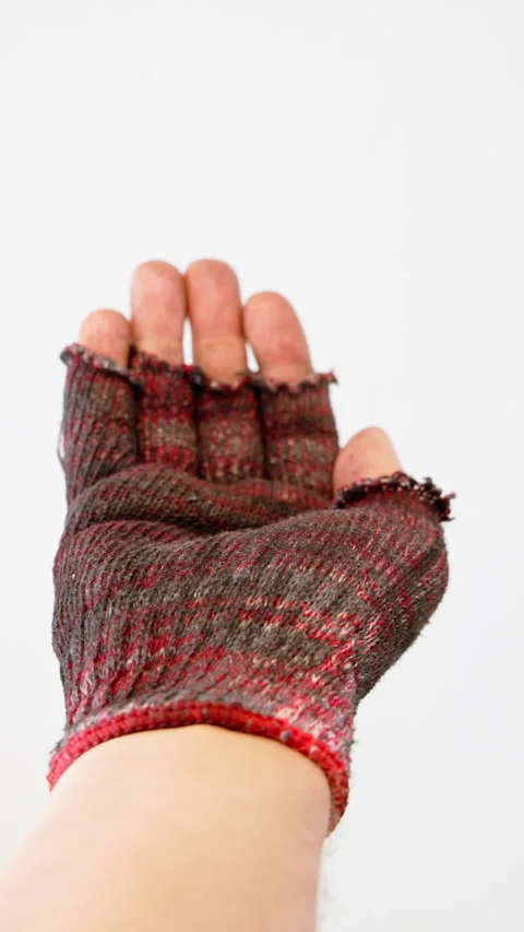 Begging and then stop gesture made by homeless person hand in fingerless glove Stock Footage 330846335