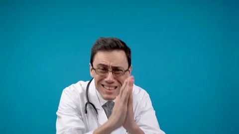 Begging physician with praying hands in studio Stock Footage 187362937