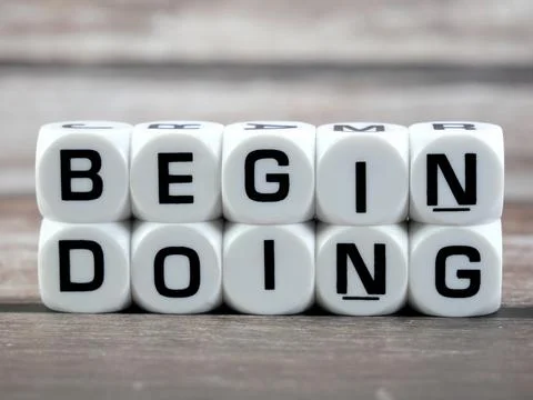 Begin doing wording  or text on white dice with black wooden background.Cop.. Stock Photos