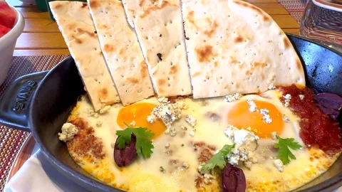 Begin your day with farm-fresh fried eggs and organic sliced bread, all prepared Stock Footage 282083435