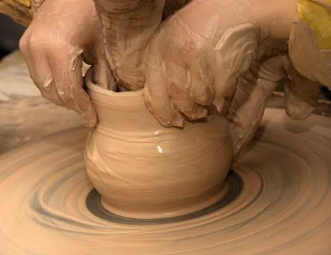 Beginner and teacher in process of making clay bowl on pottery wheel Stock Photos