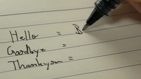 Beginner French language learner writing in French on a notebook close-up shot Stock Footage 107350654