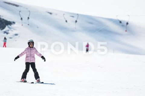 Beginner little girl learning to ski Stock Photos