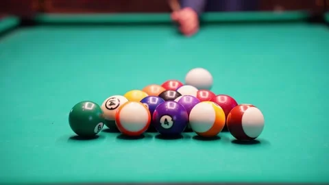 Beginner misses the break on a pool table as racked balls stay tight on green Video stock 328132391