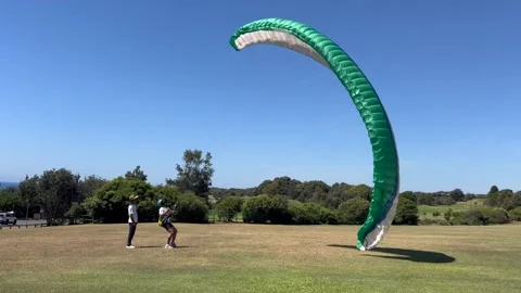 Beginner paraglider learning how to paraglide with w Teacher Stock-Footage 304764608