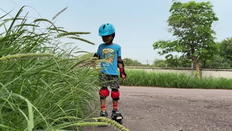 Beginner Roller Skating Practice With Young Child Wearing Safety Gear Outdoors Vídeo Stock 347127436