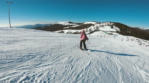 Beginner skier on a slope during winter holidays in Bulgaria - Bansko ski res Stock Footage 138962272
