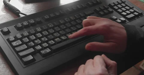 Beginner slowly tapping letters on QWERTY keyboard with fingers 4K Stock Footage 332750602