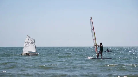 Beginner sport guy try windsurfing water activity on a Black Sea beach Ukraine Stock Footage 80870916