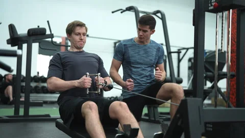 Beginner sportsman hard time practicing on rowing machine during sports training Video stock 275293157