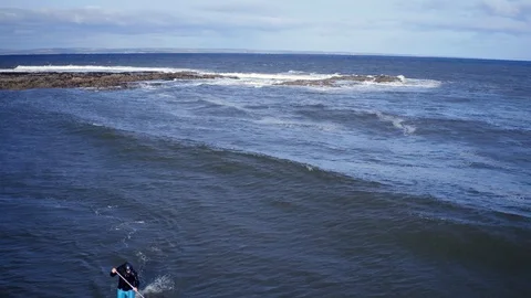 Beginner stand up paddler having fun. Tracking drone shot. Drone, 4K Stock Footage 89269521