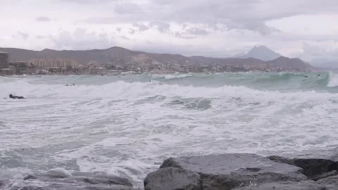 Beginner surfers in wetsuits try to catch a wave on a board in the sea. Stock Footage 303777100
