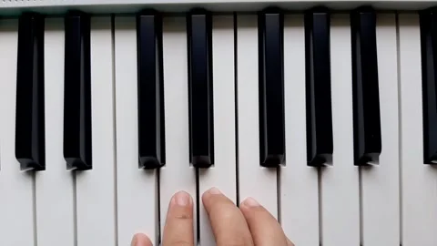 A beginner tries to play the piano	 Stock Footage 284443710