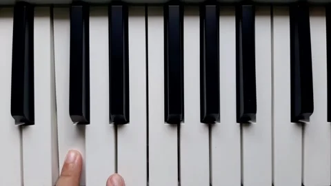 A beginner tries to play piano	 Stock Footage 284444098