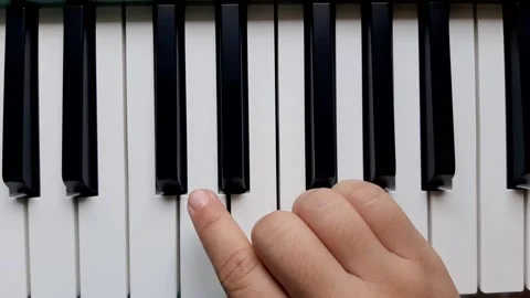 A beginner tries to play the piano	 Stock Footage 284444102