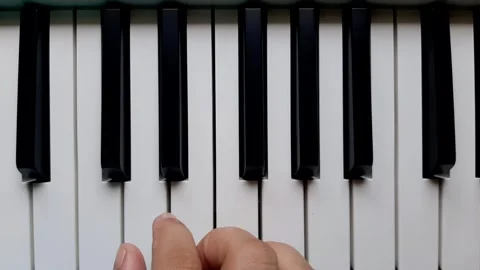 A beginner tries to play the piano	 Stock Footage 284444207