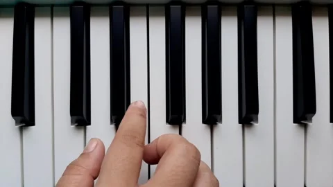 A beginner tries to play the piano	 Stock Footage 284444224