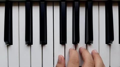 A beginner tries to play the piano	 Stock Footage 284444352