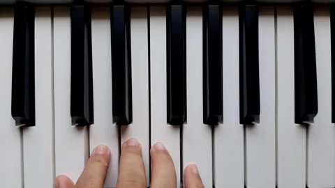 A beginner tries to play the piano	 Stock Footage 284444399