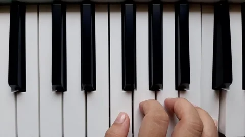 A beginner tries to play the piano	 Stock Footage 284444426