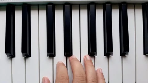 A beginner tries to play right hand on the piano	 Stock Footage 284443628