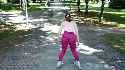 Beginner woman preparing for first downhill on inline skates Stock Footage 341477244