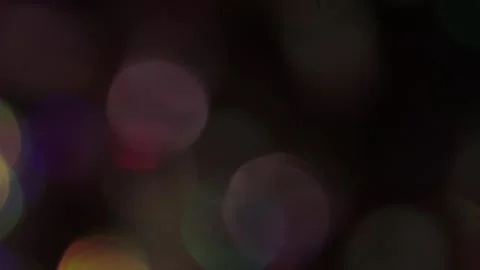 The beginning of colored bokeh light from decreasing to increasing light Stock Footage 317460292