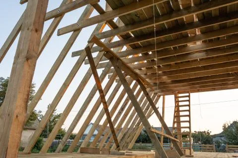 The beginning of the construction of the triangular cottage. House frame buil Stock Photos