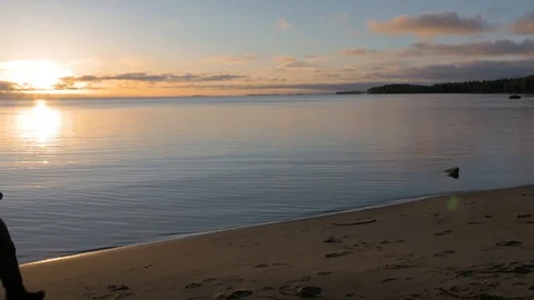 The beginning of the day. A man meets the dawn on the shore of a beautiful lake Video stock 97599209