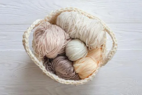 The beginning of the knitting process. Knitting needles. Basket with skeins of Stock Photos