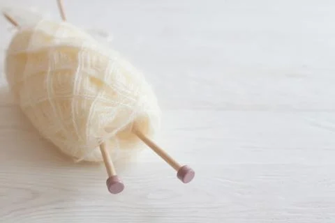 The beginning of the knitting process. Skein of white yarn. Knitting needles Stock Photos