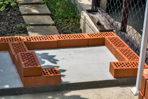 Beginning of masonry with bricks Stock Photos
