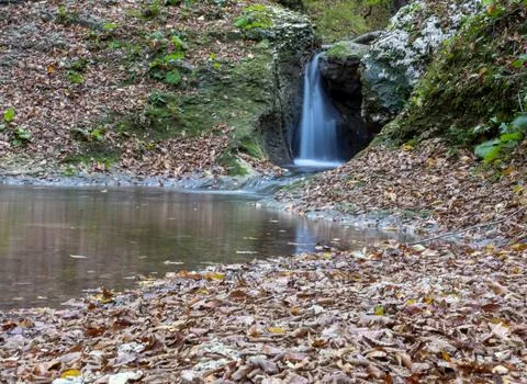 The beginning of a mountain river , a slow flow in a shallow riverbed Stock Photos